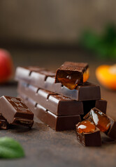 Chocolate bar with berry filling on white background. Stack of dark chocolate stuffed with berries....