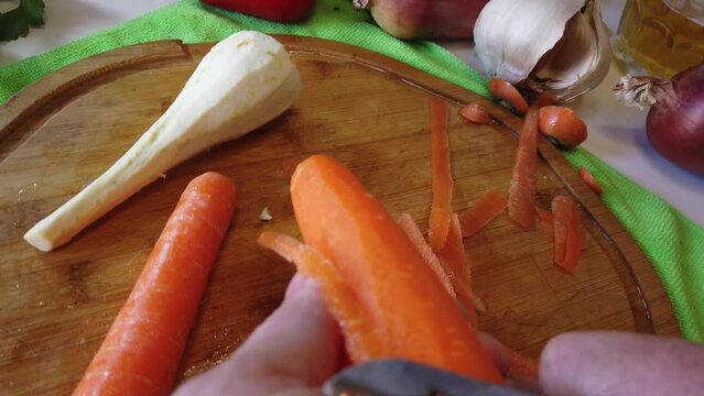Piling carrot pov close up follow shot. Healthy food preparation. Raw vegetables. High quality 4k footage