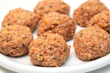 Raw meatballs on a white background - 559514158