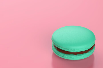 Green french macaron filled with chocolate cream on pink background