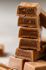 Chocolate bar with filling on brown background. Stack of dark and milk chocolate. Chocolate concept