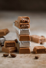Chocolate bar with filling on brown background. Stack of dark and milk chocolate. Chocolate concept