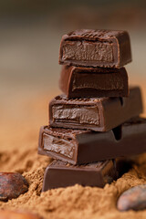 Chocolate bar with filling on brown background. Stack of dark and milk chocolate. Chocolate concept