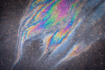 Obraz premium Abstract Color Gasoline fuel spots on Asphalt Road as Texture or Background.