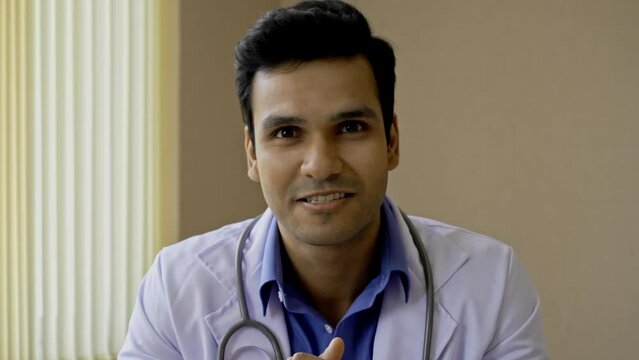 An Indian Doctor Is Giving Patient Advice Via Video Conference Or Video Call To Patients At Home Or Apartment With Internet Access. Conference Presentation On Medical Education