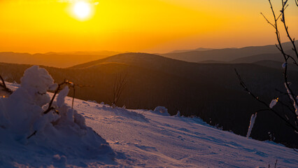 panorama of snow-capped mountains at sunset during a cold winter  mighty mountain peaks in the Polish Bieszczady mountains  mountain vegetation covered with snow © Lens Down Under