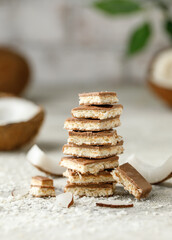 Chocolate with coconut on white background. Stack of chocolate with coconut. Chocolate pieces with...
