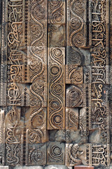 Floral Motfis decoration in the wall of Qutb Minar complex at New Delhi, India. Relief carving at the old monument. Unesco heritage site at Delhi.