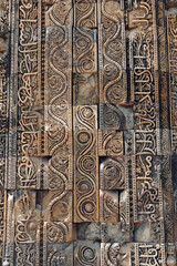 Floral Motfis decoration in the wall of Qutb Minar complex at New Delhi, India. Relief carving at the old monument. Unesco heritage site at Delhi.