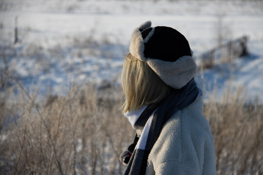 girl in winter in white clothes looks to the side