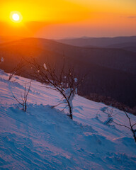 panorama of snow-capped mountains bieszczady at sunset, winter sunset seen from the top of the mountain wielka rawka © Lens Down Under