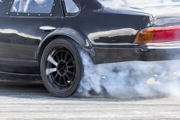 Race drift car burning tires on speed track
