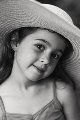 Black and white Portrait of smiling cute little girl at summer park. Happy child looking at the camera