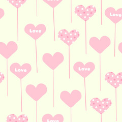 Fototapeta na wymiar Seamless pattern with topper hearts on stick holders on a yellow background in a vector for Valentine's Day
