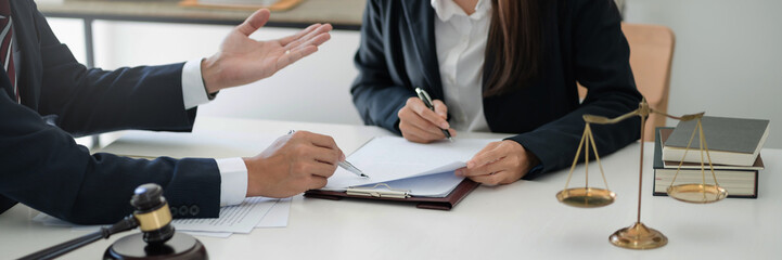 Lawyer with lawsuit meeting with client discussing with contract agreement at courtroom