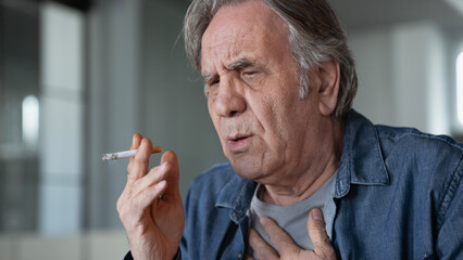 Old man smoking a cigarette - 559529106