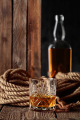 Crystal glass and bottle with rum, cognac, or whiskey.