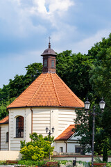 Fototapeta premium House or building on a sunny day obscured by green trees. Summer.