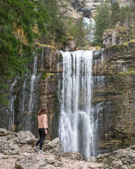 Woman looking a waterfall