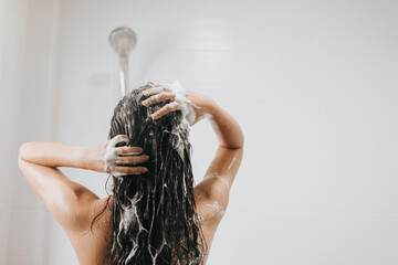Woman washing hair with shampoo and shower in bathroom, Asian female body and hair care with foam to freshness. Spa and Health care. - obrazy, fototapety, plakaty