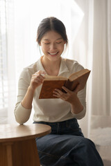 Attractive and beautiful Asian women are reading book and working at home their leisure and...