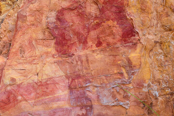 Closeup of the multicolored red rock wall background and texture with detailed