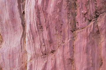 Closeup of the pink colored rock wall background and texture with detailed