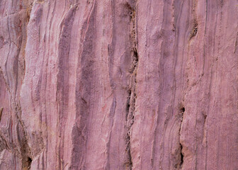 Closeup of the pink colored rock wall background and texture with detailed