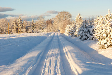 Fototapeta na wymiar Country road after a snowstorm covered with snow