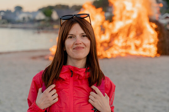 Bonfire. Portrait Of A Woman In Front Of A Large Fire.