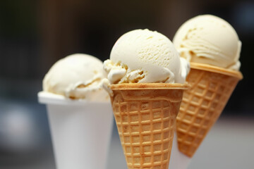 Variety of ice cream scoops in cones with chocolate and vanilla. IA Tehnology
