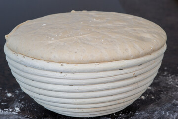 proofing basket with bread dough, preparation of food