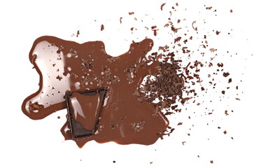 Chopped dark chocolate spilled chocolate milk puddle isolated on white, top view