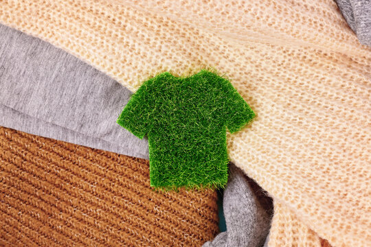 Concept for environmental friendly produced clothing with shirt made out of grass surrounded by sweaters