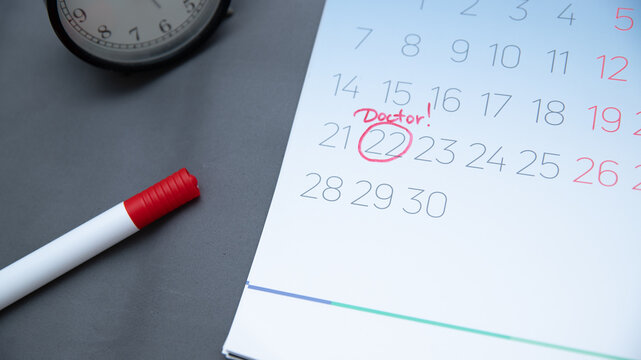 Reminder in the calendar about the appointment to the doctor, highlighted in red number in the calendar reminder of the visit to the medical office