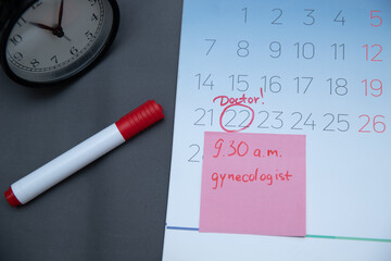 Fototapeta na wymiar Reminder in the calendar about the appointment to the doctor, highlighted in red number in the calendar reminder of the visit to the medical office