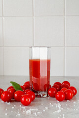 A glass of tomato juice and cherry tomatoes