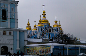 Church in Kyiv near the Verkhovna Rada. Orthodox church with blue walls and golden domes. Church with golden domes in cloudy weather. Temple of the Three Saints