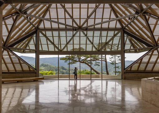Lone person photographs the trees surrounding I.M. Pei&rsquo;s futuristic Miho museum from inside the entrance Kyoto, Japan - May 20, 2015: 