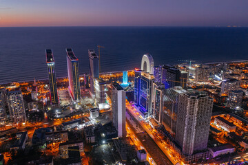 Fototapeta premium Drone aerial view of skyscrapers in night Batumi City, Georgia