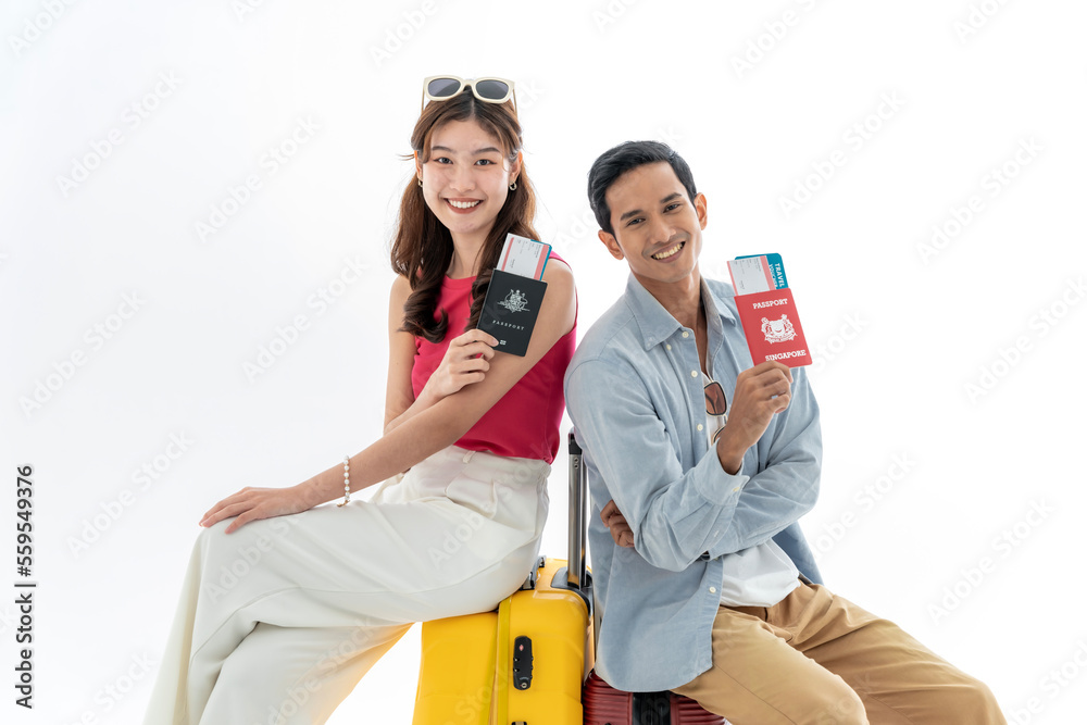 Wall mural Portrait of an Asian couple with their suitcases, passports and travel tickets. isolated on a white background