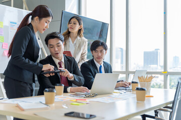 A group of young Asian businessmen Talking and planning work happily and have fun. at the company's office