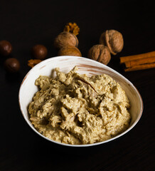 Satsivi, a Georgian poultry dish in a walnut sauce. Close-up of whore Satsivi on a dark background