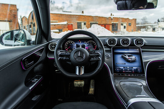 MOSCOW, RUSSIA - FEBRUARY 02, 2022. Mercedes-Benz C-Class 200 (W206), interior view. Compact luxury sedan car. Mercedes-Benz logo on the car steering wheel.
