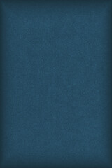 Dark blue colored paper texture. Tinted background. Textured vertical backdrop with vignetting. Large patterned surface. Fibers and irregularities are visible. Top-down