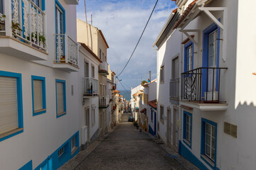 Fototapeta na wymiar Narrow steep street leading to the beach in Nazaré, Portugal