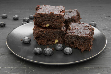 Tasty homemade brownie with blueberry, close up. 