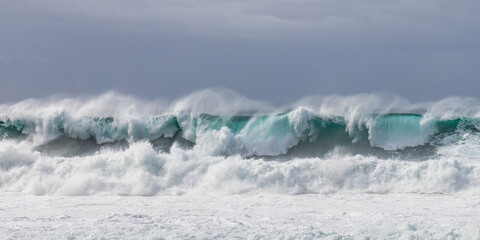 Panoramic photo of multiple layers of big crashing waves