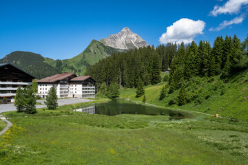 Obraz premium Village of Warth am Arlberg showing Seebach See and Biberkopf, State of Vorarlberg, Austria