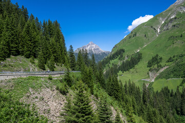 Fototapeta na wymiar Street between Lech and Warth am Arlberg toward Biberkopf Mountain, Valley of Lechtal, State of Vorarlberg, Austria